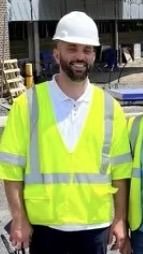 Rob Currie, PE on a job site in a hard hat and safety vest
